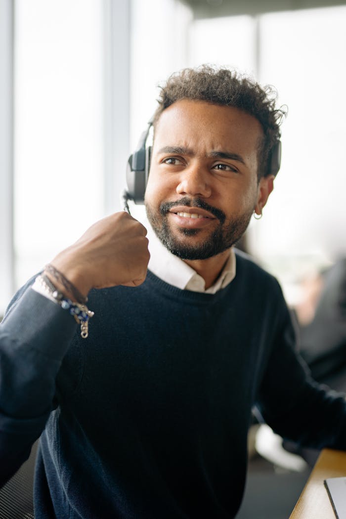 Bearded Man Holding the Headset Microphone Tip